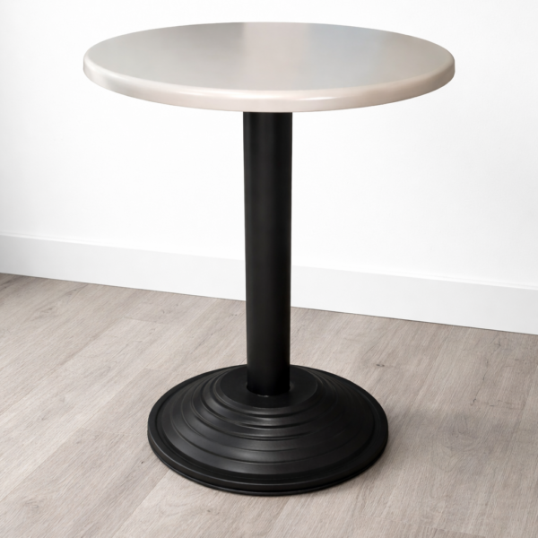 Round café table with light-colored top and black pedestal base for restaurant use