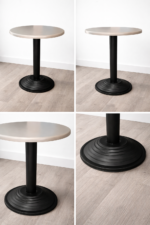 Round café table with light-colored top and black pedestal base for restaurant use