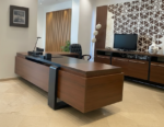 "Handcrafted executive office desk made of natural solid wood, featuring a luxury walnut finish, thick desktop, and modern architectural design with integrated side cabinet."