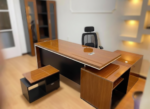 Luxury high-gloss walnut executive desk with integrated L-shaped storage cabinet and matching coffee table by Quality Furniture Egypt.