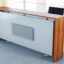 Customizable modern reception desk REC-CO-614 made of Spanish MDF wood, featuring a white and natural wood finish, available in sizes 160cm to 400cm for office reception areas.